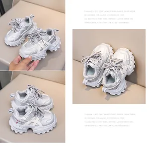 Macro detail of kids silver chunky sneakers showing breathable mesh and anti-slip thick soles