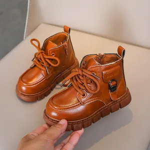 Macro detail of brown leather kids boot with side zipper and rugged rubber sole