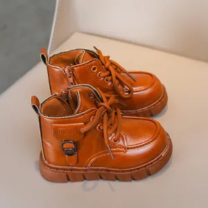 Detail of kids brown leather boots with lace-up side zipper and non-slip thick sole