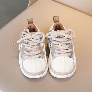 Top-down view of kids sneakers featuring a shell-toe design and breathable mesh upper