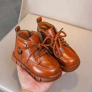 Close-up of brown children's leather boots showing zipper and durable rubber sole