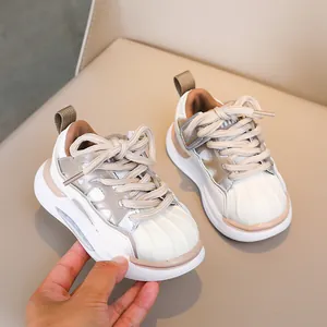 Close-up of kids' sneakers featuring a rubber shell toe and breathable cutout design