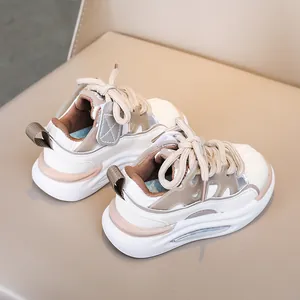 Detailed top view of kids' beige and brown patchwork sneakers with thick rope laces