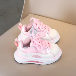 Close-up of pink children sneakers featuring shell-toe design and cushioned air soles