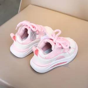 Detailed side-back view of toddler sports shoe in pink mesh and white leather