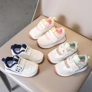 Toddler fleece sneakers in pink, blue, and green with non-slip rubber soles and cartoon patches