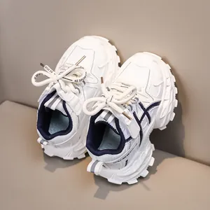 Close-up of kids' white sneakers with navy stripes and breathable mesh material