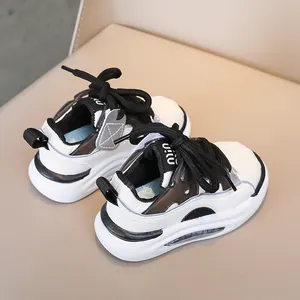 Close-up of kids' lightweight sneakers featuring breathable black and white paneled leather
