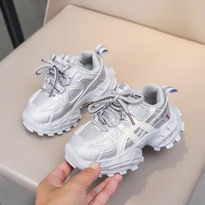 Detail of silver mesh children's sneakers with thick non-slip soles and red accents