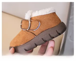 Detail of children's brown suede snow boots with white faux fur lining and non-slip sole