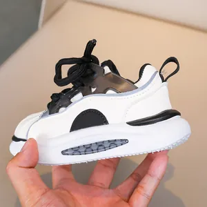 Detailed view of kids' lightweight non-slip sneakers with black and white mesh design