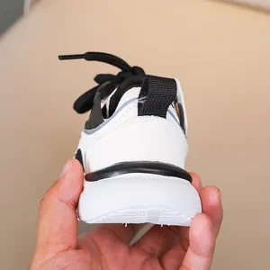 Close-up of children's sneakers featuring a thick non-slip sole and heel pull tab