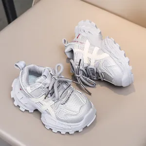 Detail of children's grey sneakers showing breathable mesh upper and anti-slip rubber sole