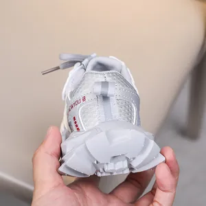 Detailed view of kids breathable mesh sneaker with thick geometric sole and logo