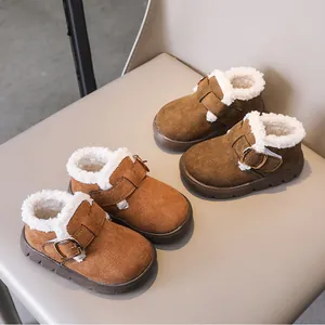 Detail view of winter kids shoes with warm faux lamb wool lining and metal buckle decor