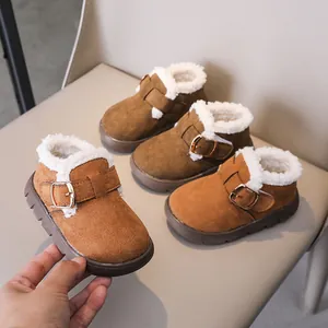 Detail of kids winter boots with warm faux shearling lining and brown suede finish