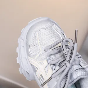 Detail of silver grey mesh sneakers with KE SPORTS logo laces and anti-slip thick sole