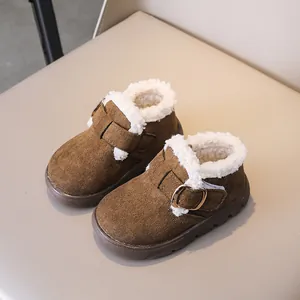 Detail of plush lamb wool lining and suede finish on brown winter kids snow boots