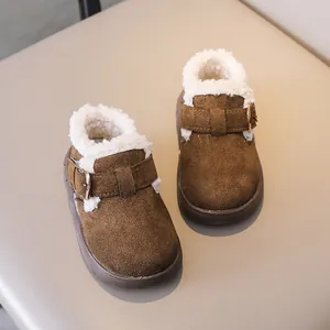 Detailed close-up of brown suede kids winter shoes with cozy fleece lining and buckle strap