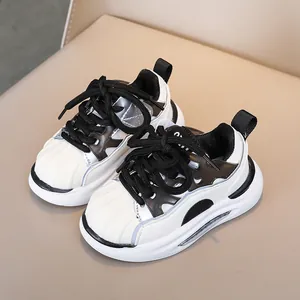 Classic black and white kids' sneakers with shell toe design and thick cushioning sole