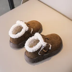 Close-up of children brown winter boots featuring plush lamb wool lining and metal buckle
