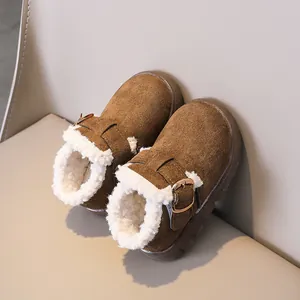 Detail of warm brown suede kids winter boots with thick white faux lamb wool lining