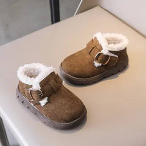 Close-up of brown suede toddler winter boots with warm white faux lamb wool lining