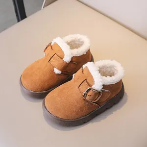 Close-up of brown children's winter boots with warm faux lamb wool lining and metal buckle