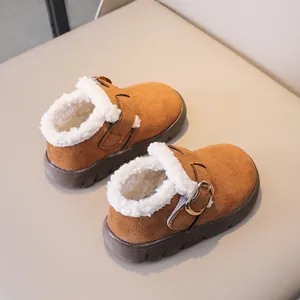 Detailed macro view of caramel winter boots with warm faux lamb wool lining and side metal buckle