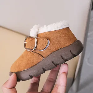 Close-up of kids winter snow boots with warm faux lamb wool lining and buckle detail