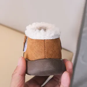 Detailed view of the warm lamb wool lining and brown suede finish on toddler winter boots