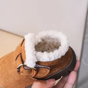 Close-up of children's winter boots with thick faux lamb wool lining and suede texture