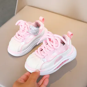 Pink and white toddler sneakers with shell-toe design and thick cushioned soles