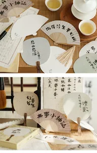 Macro view of traditional Chinese paper fans with black calligraphy and bamboo frames