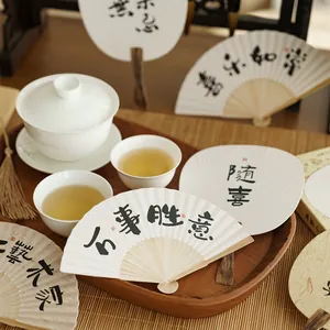 Ancient style folding fans with calligraphy and Zen-inspired tea set scene