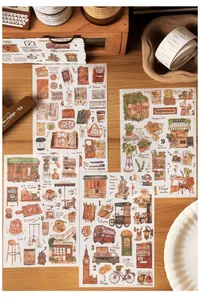 Detailed view of vintage illustration stickers on a rustic wooden table with candles