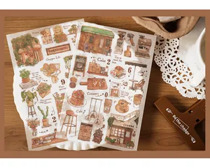 Flat lay of vintage coffee and botanical aesthetic washi stickers on wooden desk