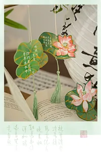 Detailed close-up of lotus flower bookmarks with green silk tassels and Chinese calligraphy