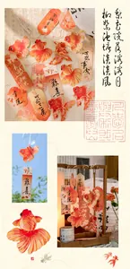 Detail of traditional Chinese goldfish bookmarks with tassels and auspicious calligraphy