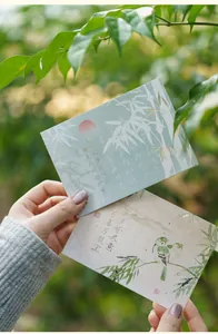 Close-up of gold-stamped greeting cards featuring bamboo patterns and Chinese calligraphy