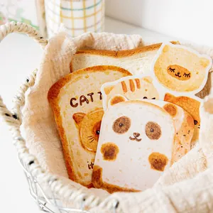 Cute cartoon bread-shaped postcards featuring panda and cat illustrations in a basket