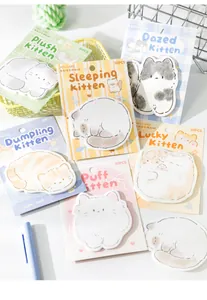 Close-up of cute cat-shaped sticky notes with pastel colors and stationary props