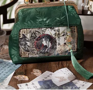 Macro detail of vintage green satin ita bag with bamboo leaf jacquard and long tassel