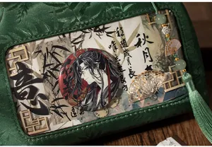 Macro detail of dark green silk ita bag with traditional Chinese patterns and tassels