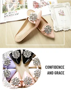 Close-up of pink patent leather pointed-toe mules with sparkling crystal buckle detail