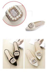 Detailed view of women's pointed-toe mule flats featuring ornate pearl and rhinestone buckle