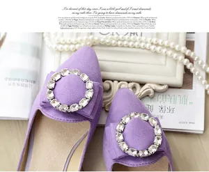 Macro detail of purple pointed flat shoe with rhinestone buckle and elegant bow decoration