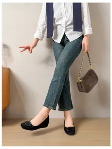 Chic black round toe suede flats with a square buckle shown in a stylish daily outfit