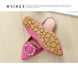 Detail of rose pink suede flat shoes with crystal buckle and non-slip rubber sole