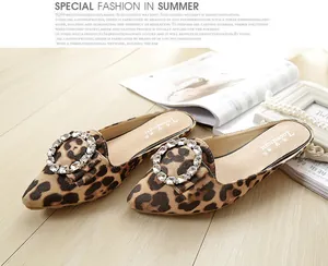 Detailed top view of leopard print pointed toe mule flat with sparkling rhinestone buckle